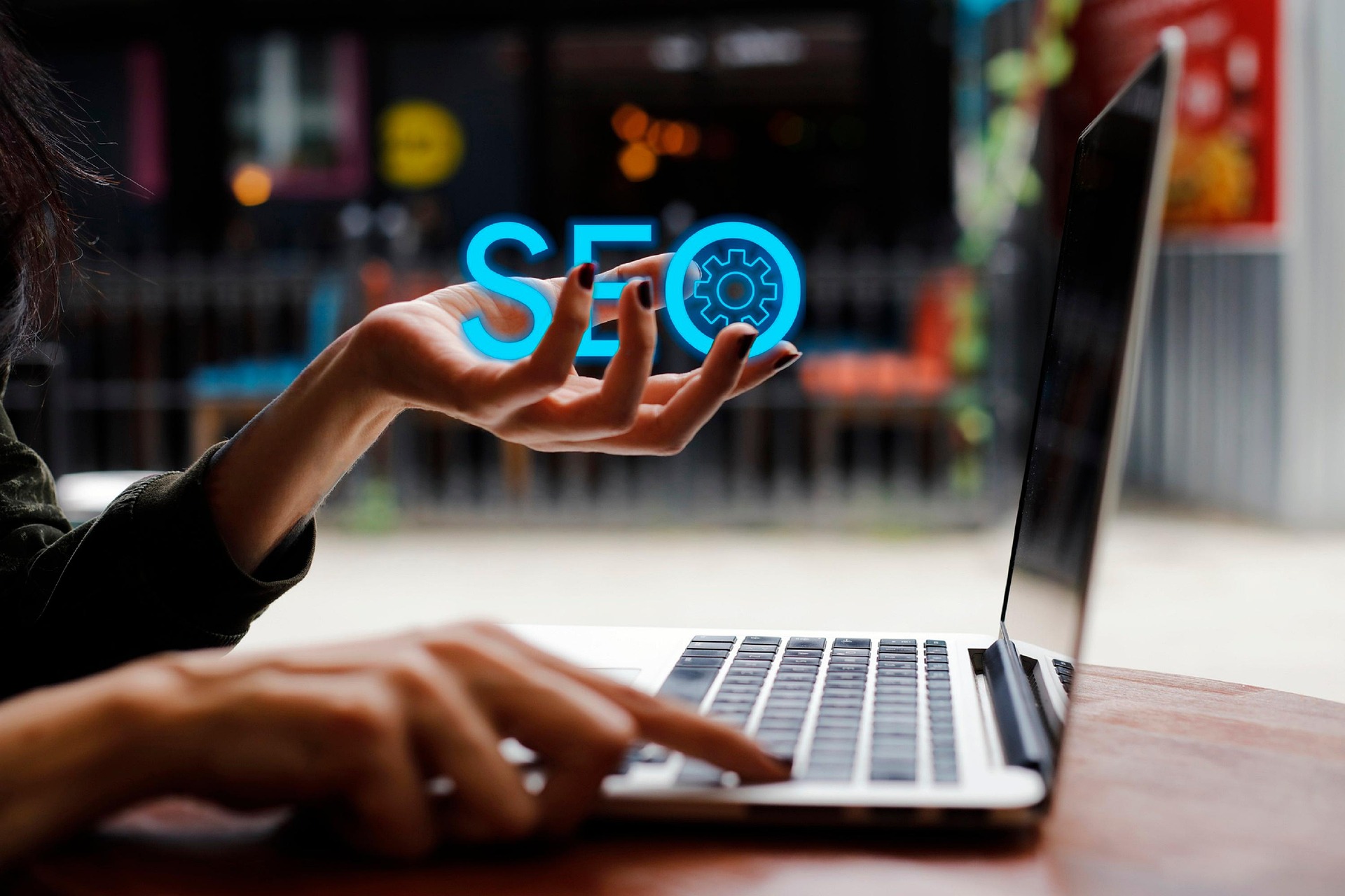 Person working on laptop with SEO holographic display, representing local SEO services for Detroit businesses